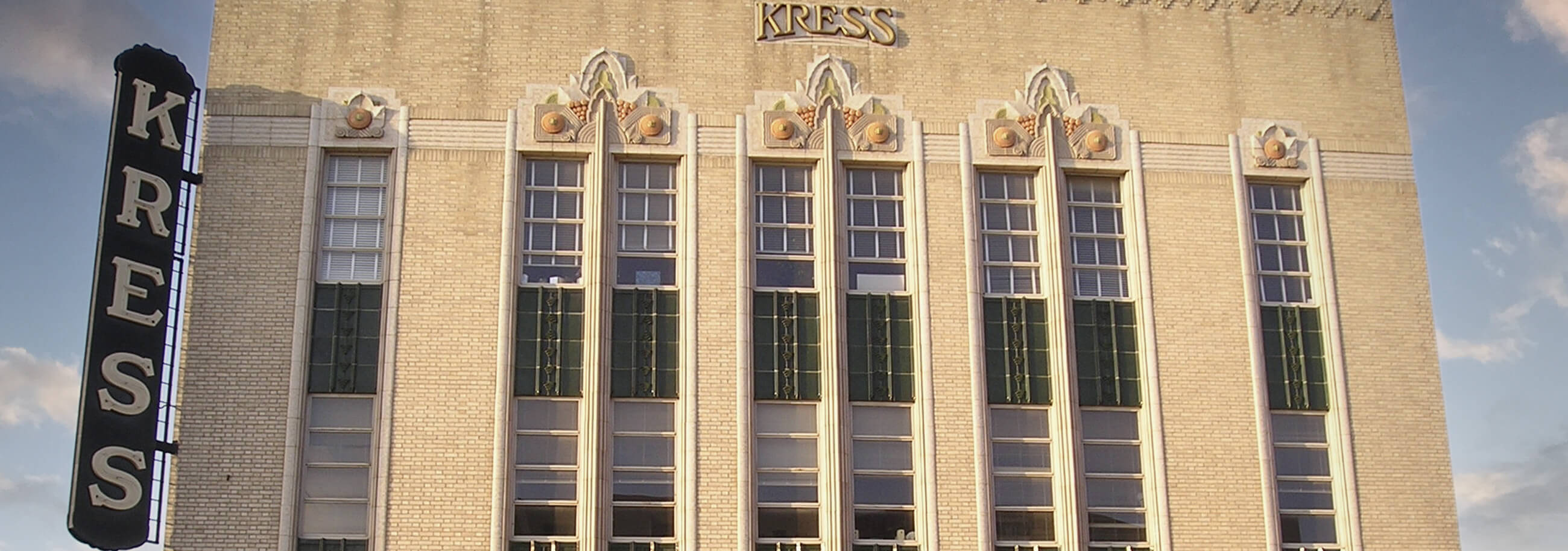 exterior of Kress building with clouds and blue sky overhead