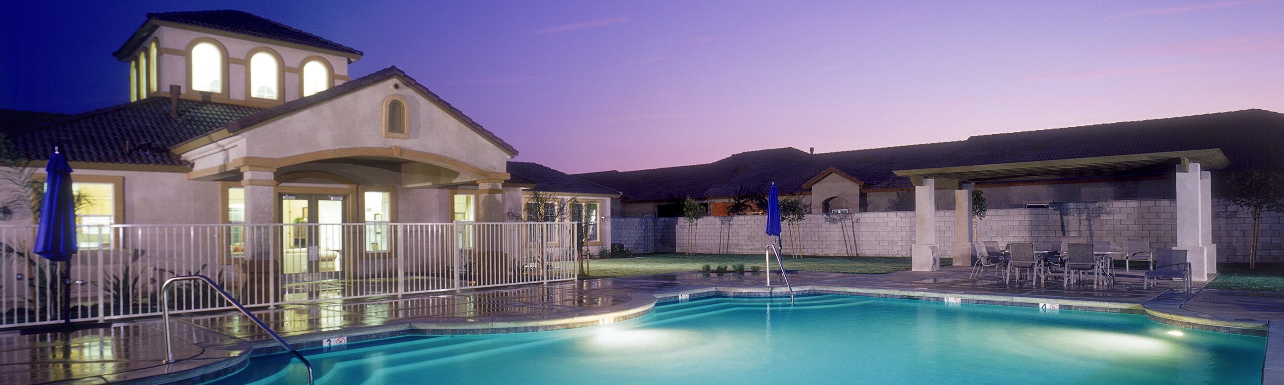 a fenced-in pool area of a clubhouse